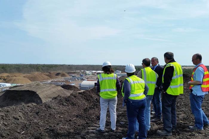 Workers look from afar at AOE plant