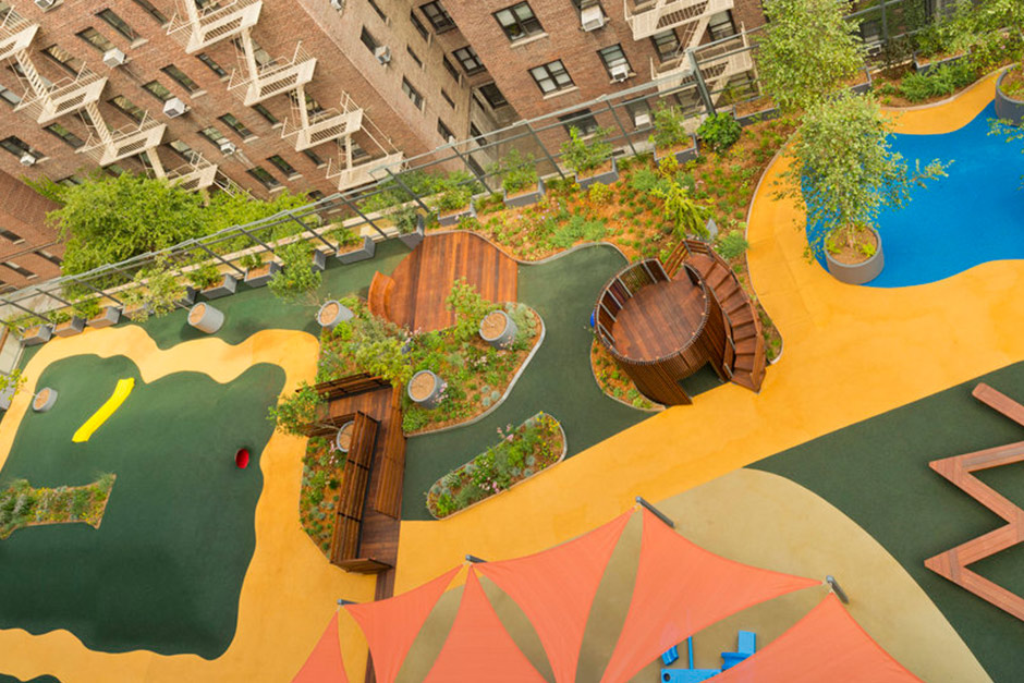 Angled overhead view of green roof building with pool and other elements