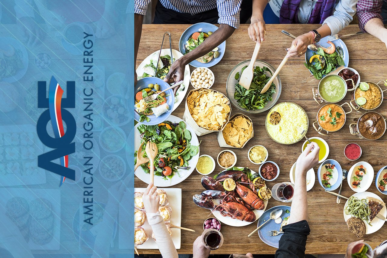 AOE Logo on top of overhead shot of full table of friends eating with full plates