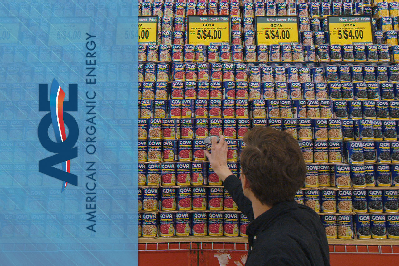 AOE Logo on top of image of man looking at canned products in supermarket