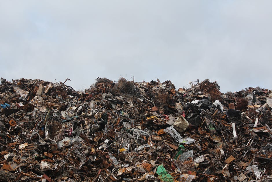 Side view of trash pile in dump